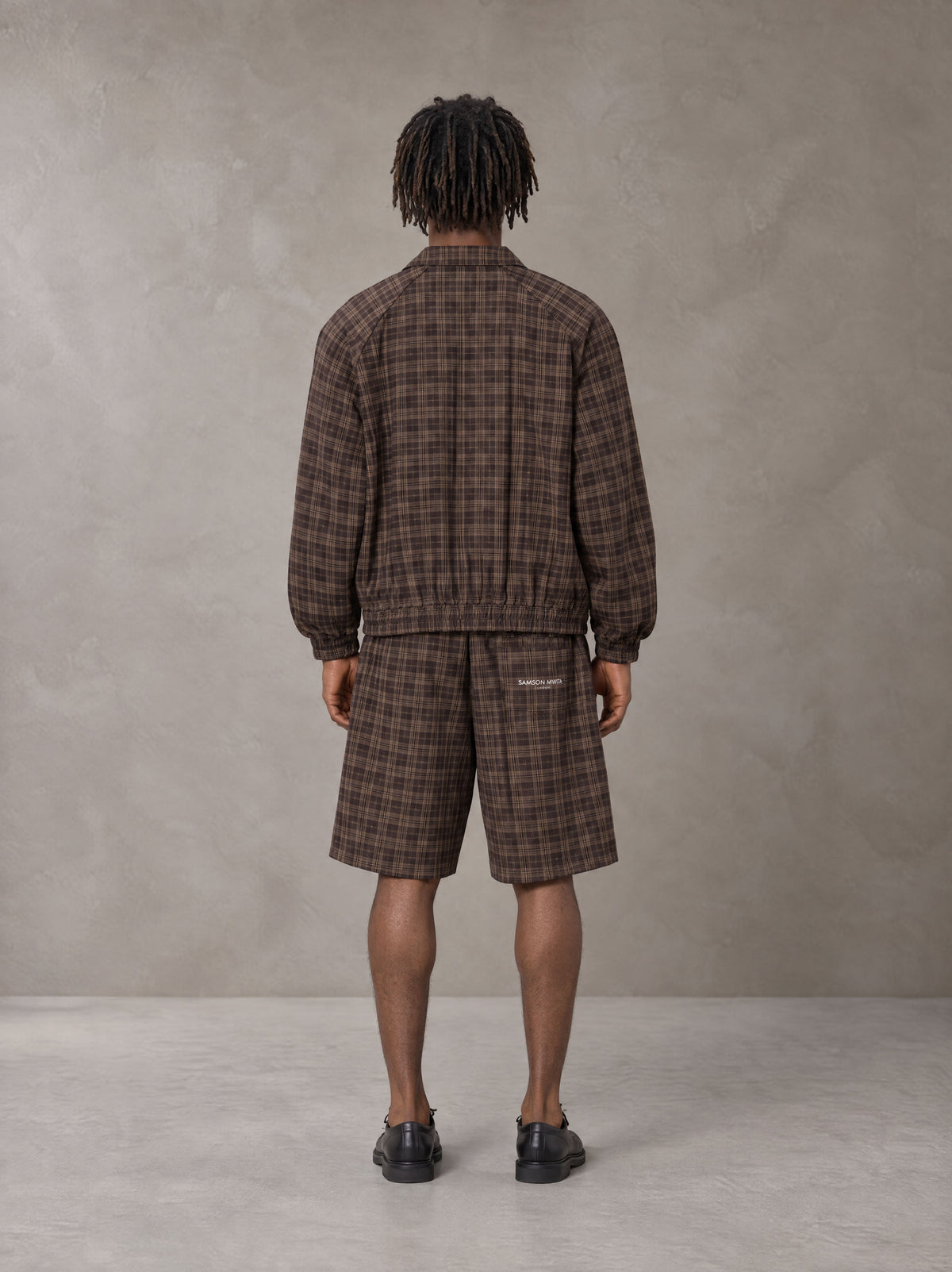 Model wearing the SM Meridian Shorts in Espresso, rear view.