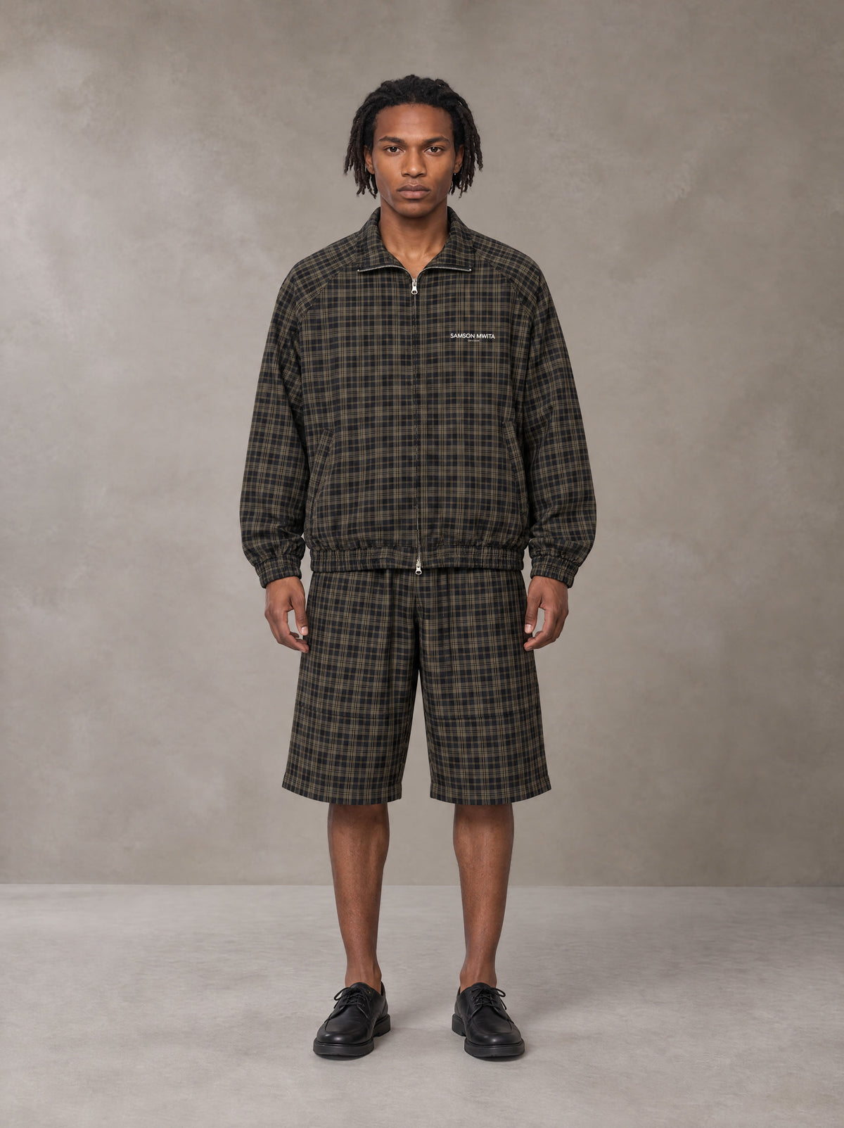 Model wearing the SM Meridian Shorts in Loden, front view.
