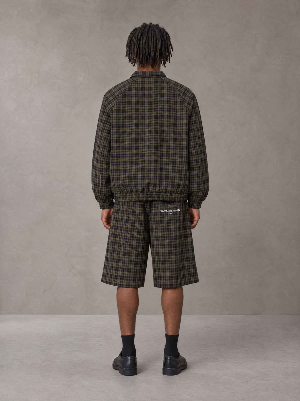 Model wearing the SM Meridian Shorts in Loden, rear view.