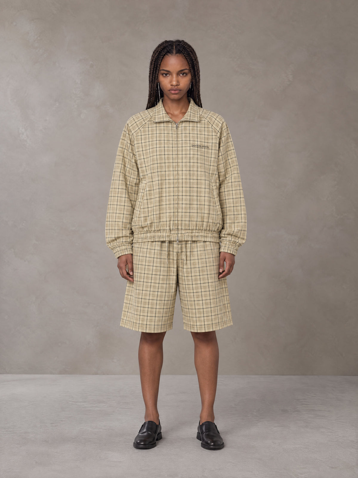 Model wearing the SM Meridian Shorts in Ecru, front view.