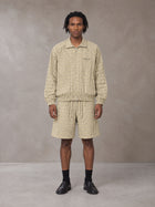 Model wearing the SM Meridian Shorts in Ecru, front view.