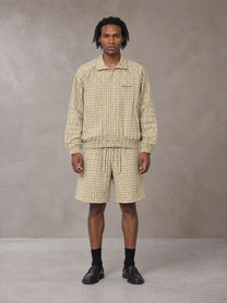 Model wearing the SM Meridian Shorts in Ecru, front view.
