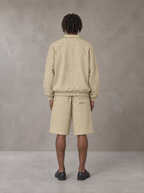 Model wearing the SM Meridian Shorts in Ecru, rear view.