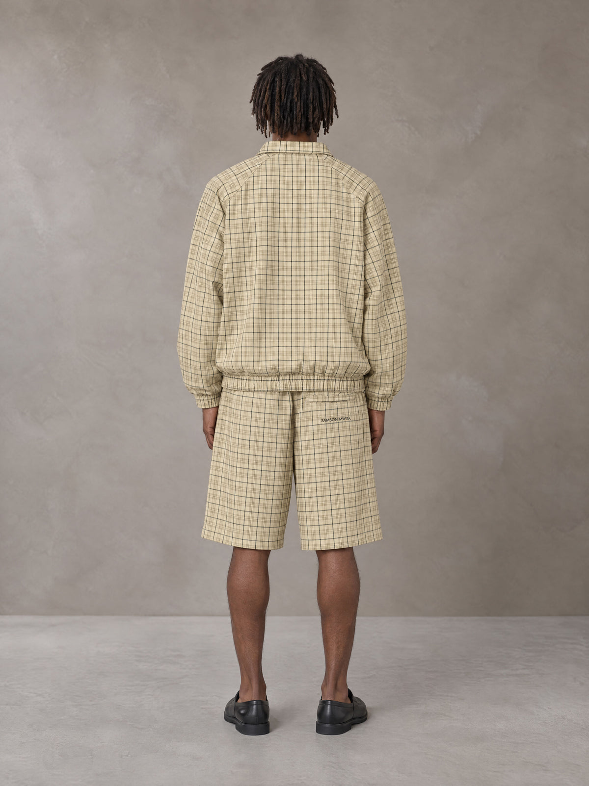 Model wearing the SM Meridian Shorts in Ecru, rear view.