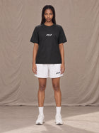 Model wearing the SM Motion Mesh Shorts in Lucent White, front view.