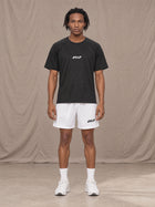 Model wearing the SM Motion Mesh Shorts in Lucent White, front view.