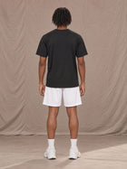 Model wearing the SM Motion Mesh Shorts in Lucent White, rear view.