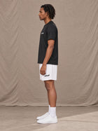 Model wearing the SM Motion Mesh Shorts in Lucent White, side profile.