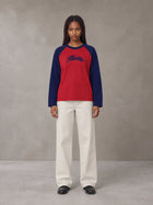 Model wearing SM Retro Raglan Long-Sleeve T-shirt in Crimson, front view.