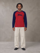 Model wearing SM Retro Raglan Long-Sleeve T-shirt in Crimson, front view.
