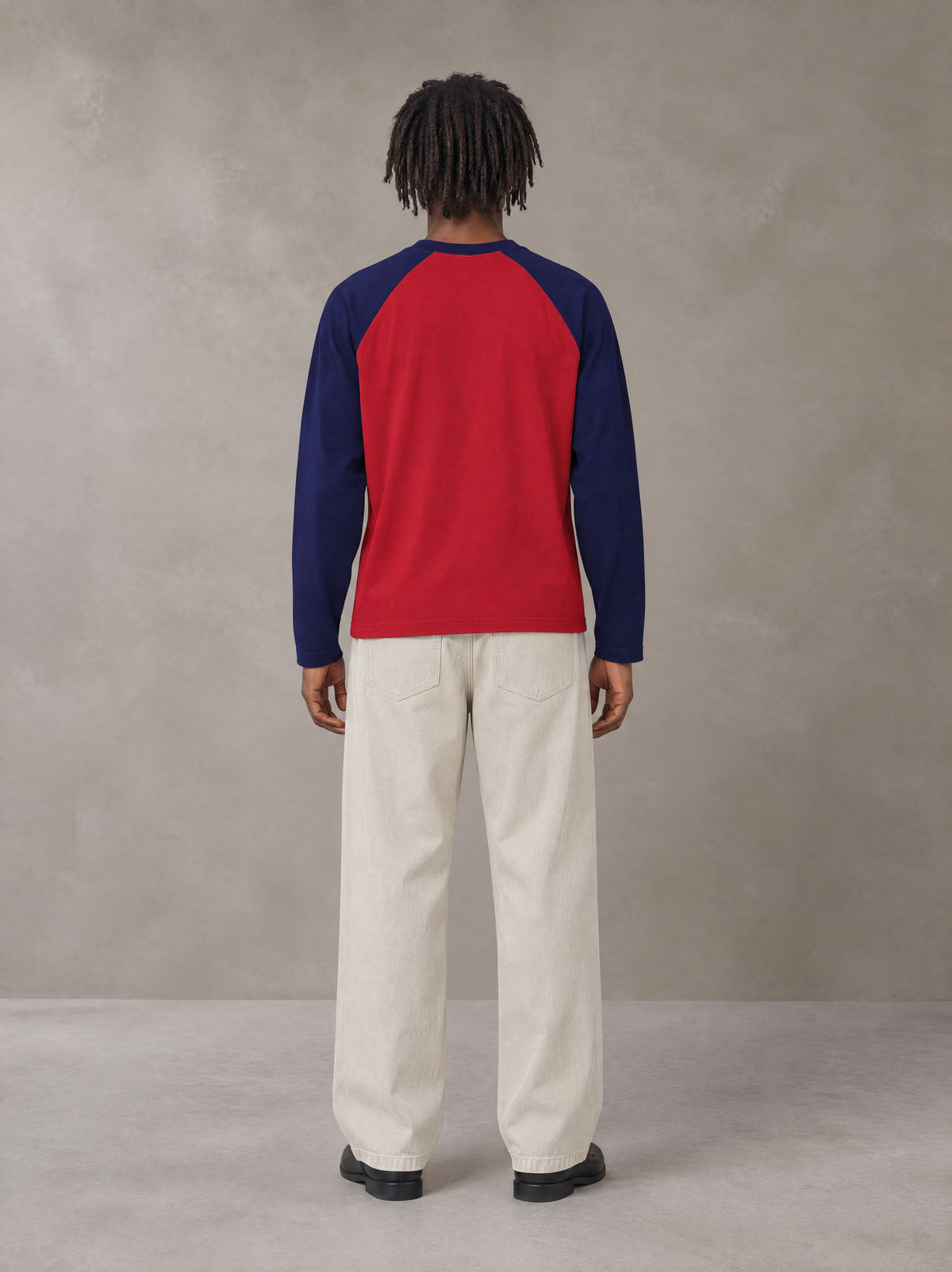Model wearing SM Retro Raglan Long-Sleeve T-shirt in Crimson, rear view.