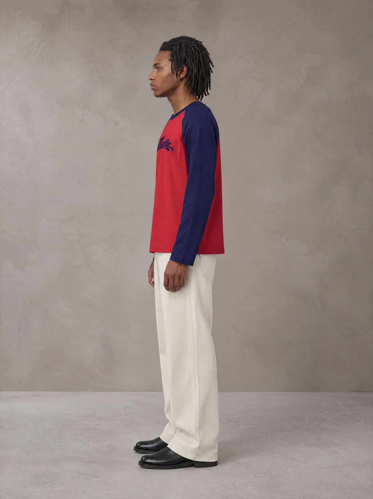 Model wearing SM Retro Raglan Long-Sleeve T-shirt in Crimson, side profile.