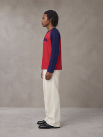 Model wearing SM Retro Raglan Long-Sleeve T-shirt in Crimson, side profile.