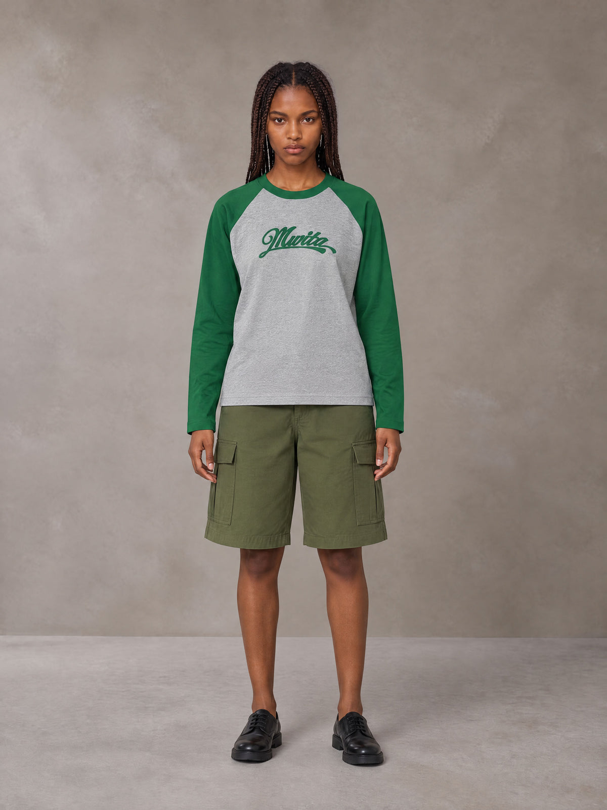 Model wearing SM Retro Raglan Long-Sleeve T-shirt in Heather Grey, front view.