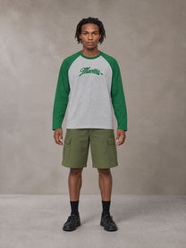 Model wearing SM Retro Raglan Long-Sleeve T-shirt in Heather Grey, front view.