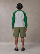 Model wearing SM Retro Raglan Long-Sleeve T-shirt in Heather Grey, rear view.