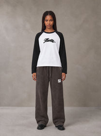 Model wearing SM Retro Raglan Long-Sleeve T-shirt in Lucent White, front view.