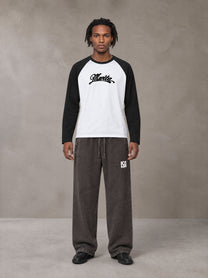 Model wearing SM Retro Raglan Long-Sleeve T-shirt in Lucent White, front view.