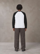 Model wearing SM Retro Raglan Long-Sleeve T-shirt in Lucent White, rear view.