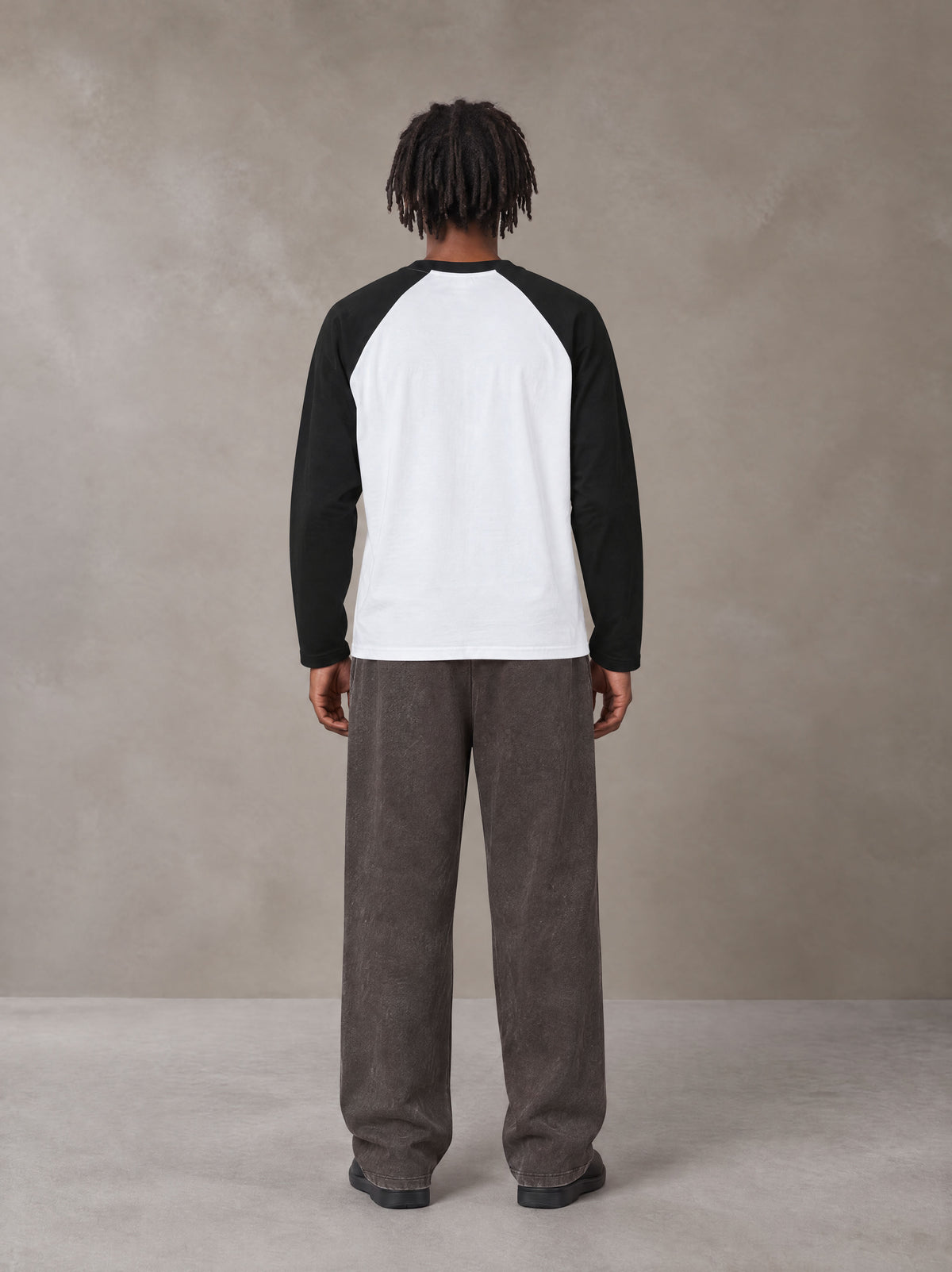 Model wearing SM Retro Raglan Long-Sleeve T-shirt in Lucent White, rear view.