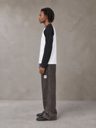 Model wearing SM Retro Raglan Long-Sleeve T-shirt in Lucent White, side profile.