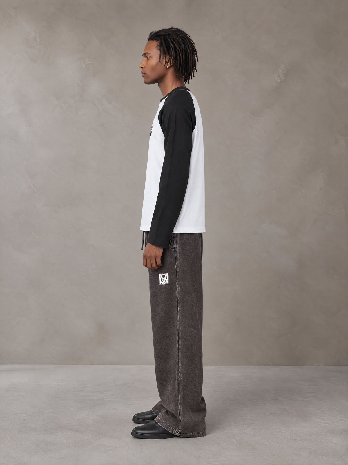 Model wearing SM Retro Raglan Long-Sleeve T-shirt in Lucent White, side profile.