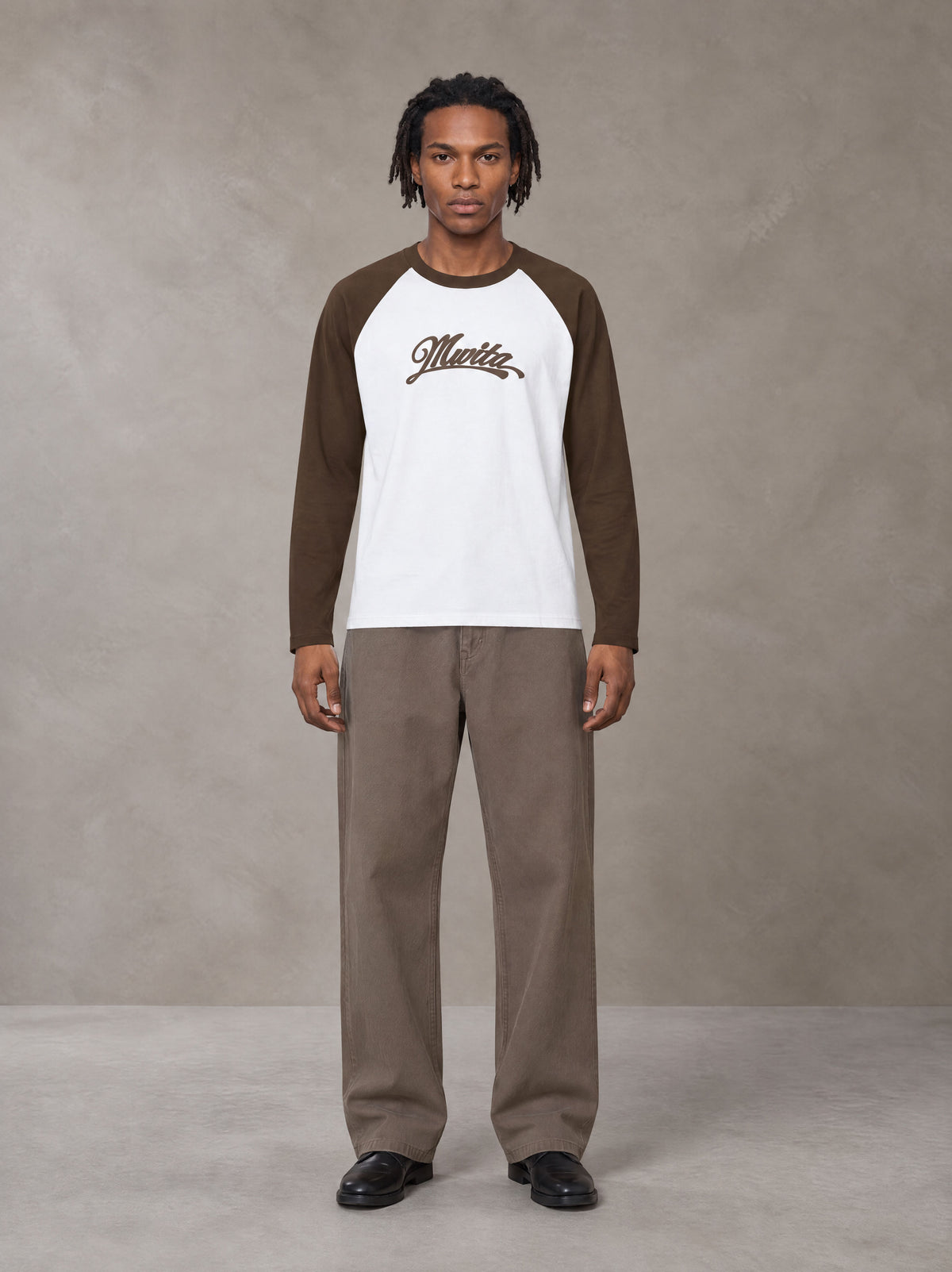 Model wearing SM Retro Raglan Long-Sleeve T-shirt in Lucent White, front view.