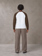 Model wearing SM Retro Raglan Long-Sleeve T-shirt in Lucent White, rear view.