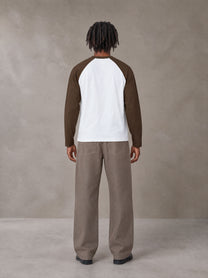 Model wearing SM Retro Raglan Long-Sleeve T-shirt in Lucent White, rear view.