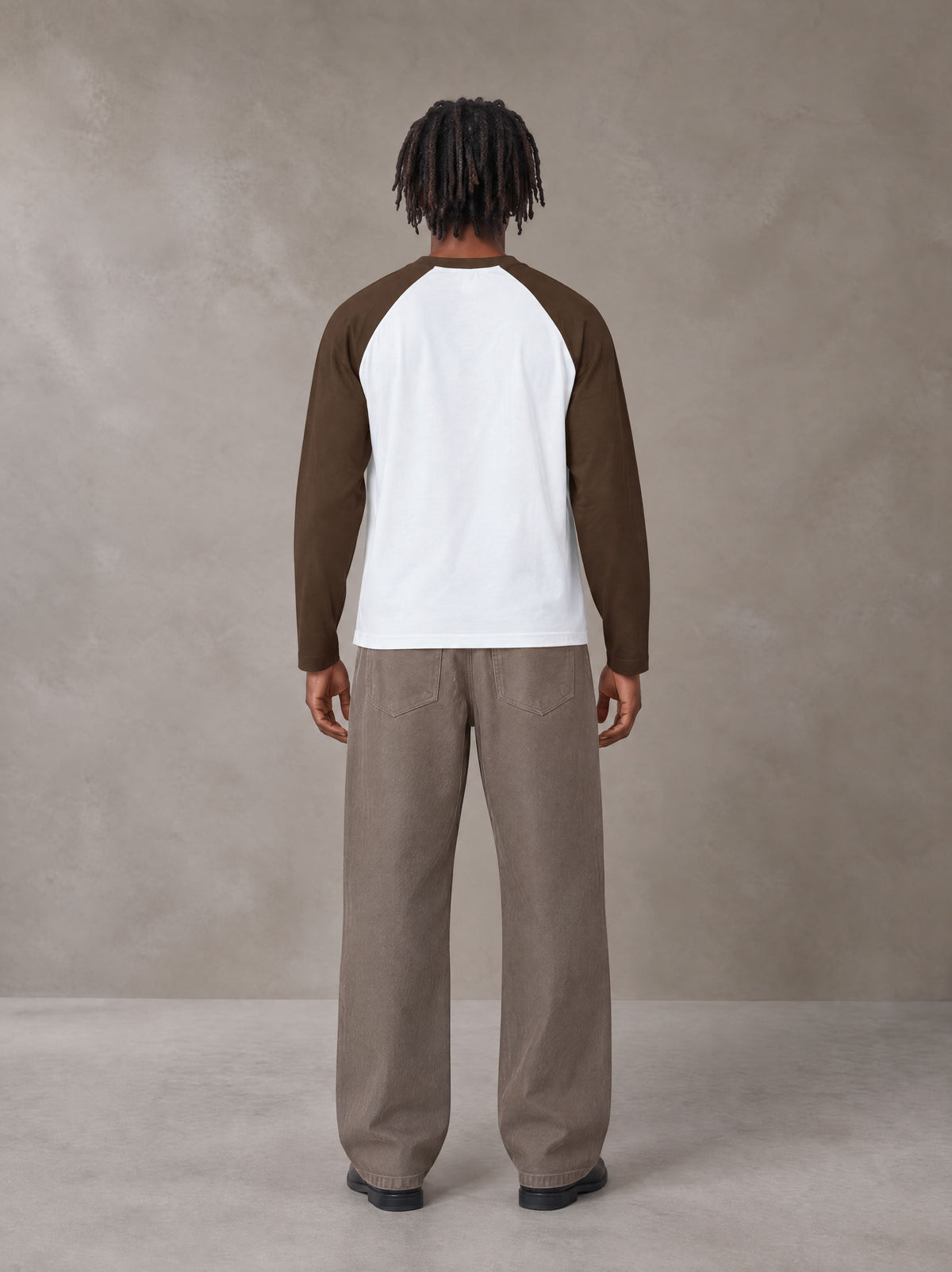 Model wearing SM Retro Raglan Long-Sleeve T-shirt in Lucent White, rear view.