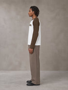 Model wearing SM Retro Raglan Long-Sleeve T-shirt in Lucent White, side profile.
