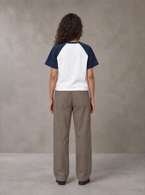 Model wearing SM Retro Raglan T-shirt in Oxford Navy, rear view.