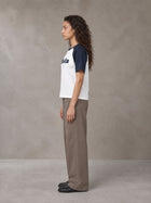 Model wearing SM Retro Raglan T-shirt in Oxford Navy, side profile.