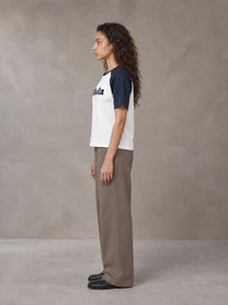 Model wearing SM Retro Raglan T-shirt in Oxford Navy, side profile.