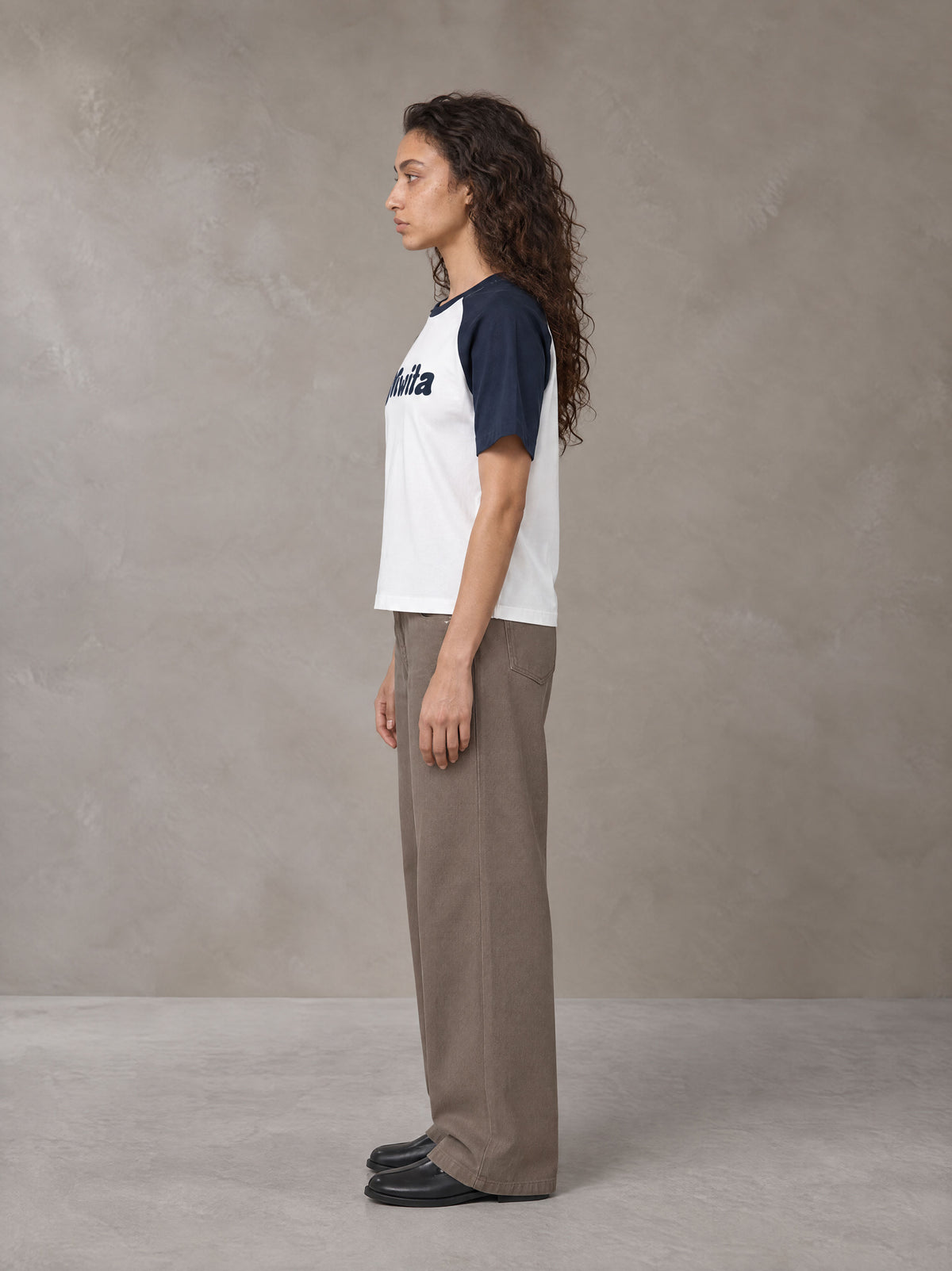 Model wearing SM Retro Raglan T-shirt in Oxford Navy, side profile.