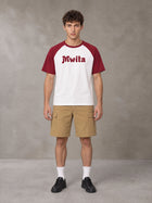 Model wearing SM Retro Raglan T-shirt in Burgundy, front view.