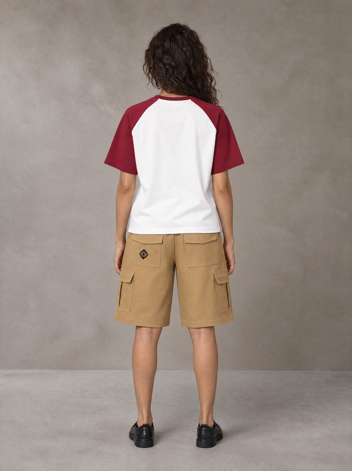 Model wearing SM Retro Raglan T-shirt in Burgundy, rear view.
