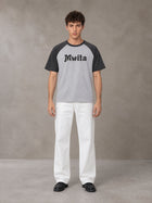Model wearing SM Retro Raglan T-shirt in Deep Charcoal, front view.