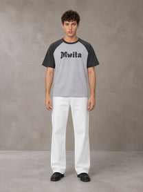 Model wearing SM Retro Raglan T-shirt in Deep Charcoal, front view.