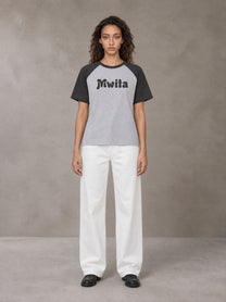 Model wearing SM Retro Raglan T-shirt in Deep Charcoal, front view.