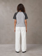 Model wearing SM Retro Raglan T-shirt in Deep Charcoal, rear view.