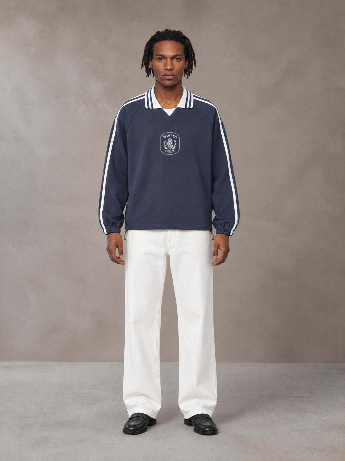 Model wearing SM Royal Emblem Panel Sweatshirt in Chambray, front view.
