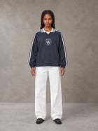 Model wearing SM Royal Emblem Panel Sweatshirt in Chambray, front view.