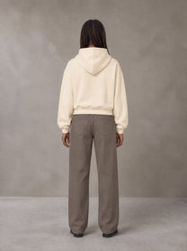 Model wearing SM Sig. Boxy Hoodie in Apricot Tint, rear view.