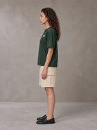 Model wearing SM Sig. Earth T-shirt in Alpine Green, side profile.