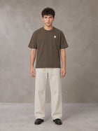 Model wearing SM Sig. Earth T-shirt in Brown, front view.