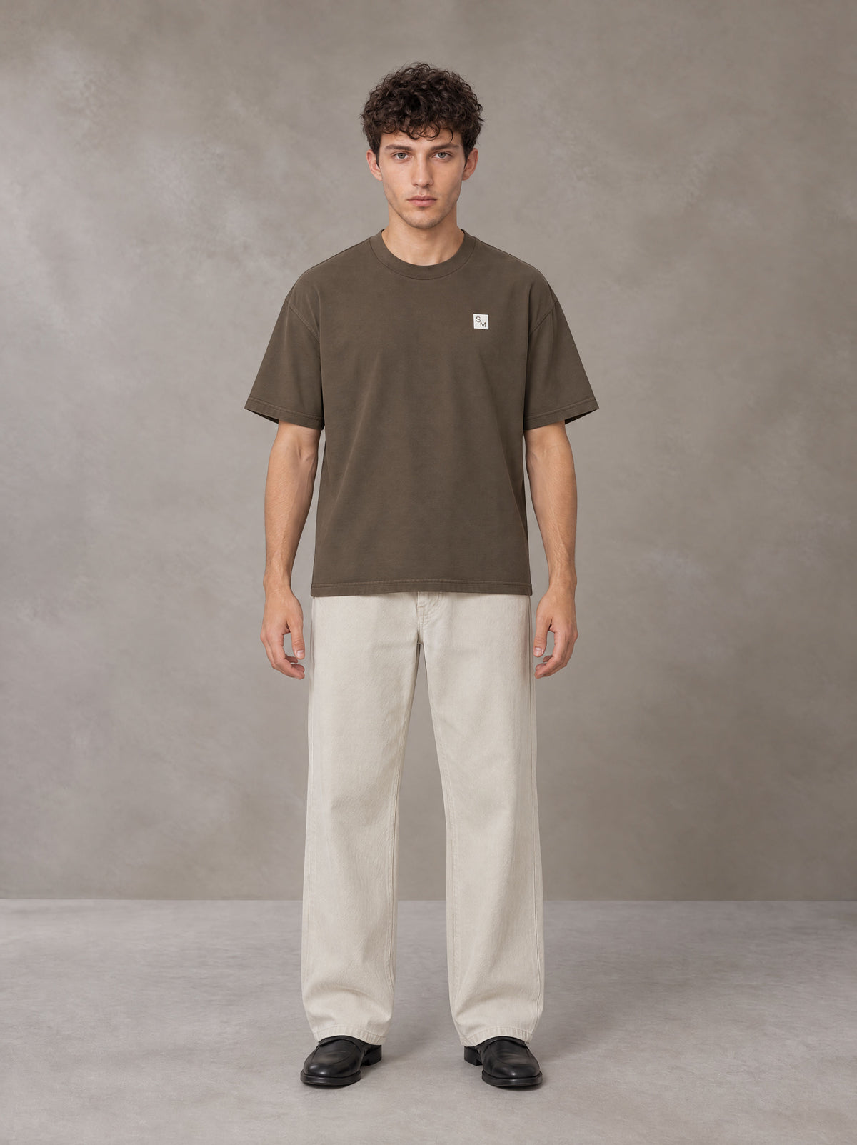 Model wearing SM Sig. Earth T-shirt in Brown, front view.