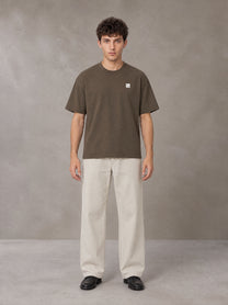 Model wearing SM Sig. Earth T-shirt in Brown, front view.