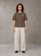 Model wearing SM Sig. Earth T-shirt in Brown, front view.