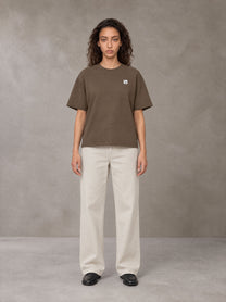 Model wearing SM Sig. Earth T-shirt in Brown, front view.